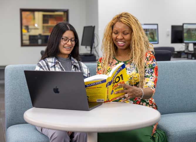 RICE mentor and student reading a book.