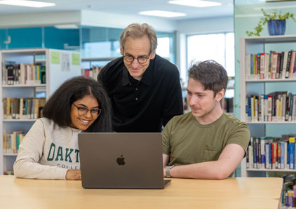 Two students working with a tutor.